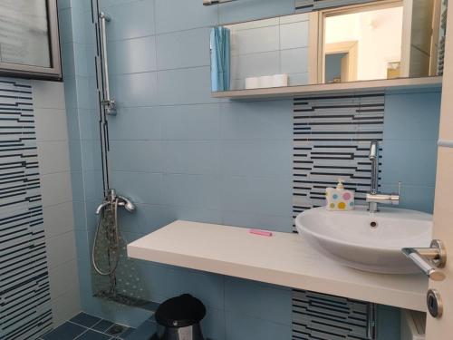 a bathroom with a sink and a mirror at Sea & Summit Pool Villa in Platamonas