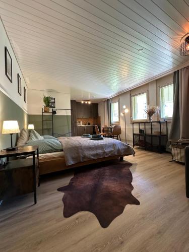 a large bedroom with a large bed and a table at Alpine Nest Tiltlis, Garden, Central, Lucerne in Engelberg
