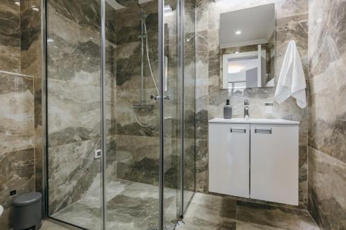a bathroom with a shower stall and a sink at ARABESQUE Apartments & Suite in Ulcinj
