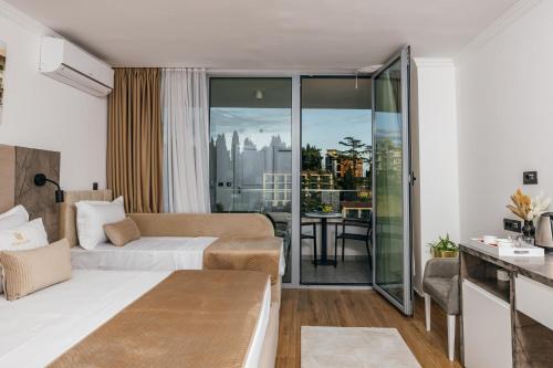 a hotel room with a bed and a living room at ARABESQUE Apartments & Suite in Ulcinj