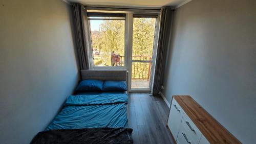 a small room with two beds and a window at Spanko u Jadzi in Wałbrzych