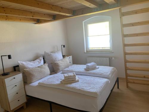 a bedroom with a bed with two towels on it at Ferienhaus Kobel in Stromberg