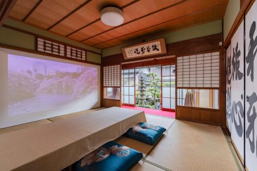 a room with a bed and a large window at 民泊YADOOR East House & West House in Iga
