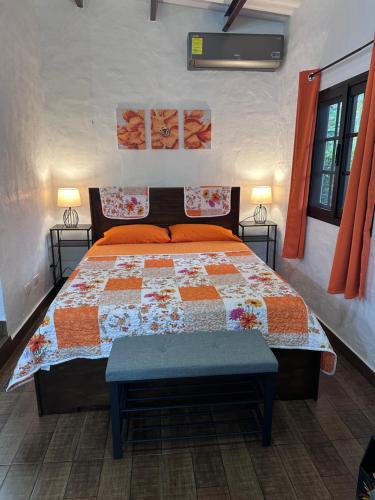 a bedroom with a bed with a quilt on it at Don Lioni in El Valle de Antón