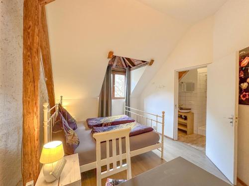 a bedroom with a bed and a table in a room at Quelle in Bernkastel-Kues