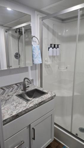 a bathroom with a sink and a shower at Happier in the Keys Waterfront Tiny Home in Key Largo