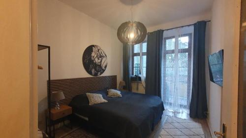 a bedroom with a bed and a large window at Am Pontepark in Görlitz