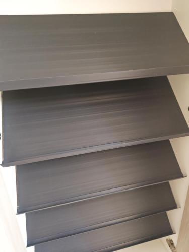 a shelf in a closet with gray shelves at StadtLeben東北ゲートウエイ2新築広々仙台駅徒歩5分 in Sendai