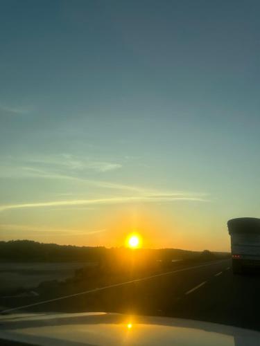 a sunset on the highway with a truck at The Sunset Los Naranjos in Santa Marta