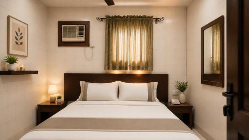 a bedroom with a large bed and two night stands at DeBoss Hotel in Ikeja