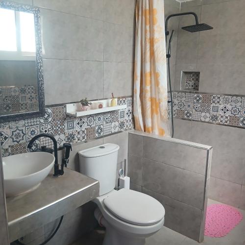 a small bathroom with a toilet and a sink at Sultana in Ech Chorfa