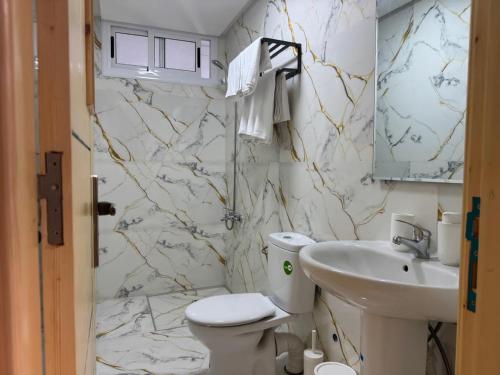 a bathroom with a toilet and a sink at Dalal house in Chefchaouen
