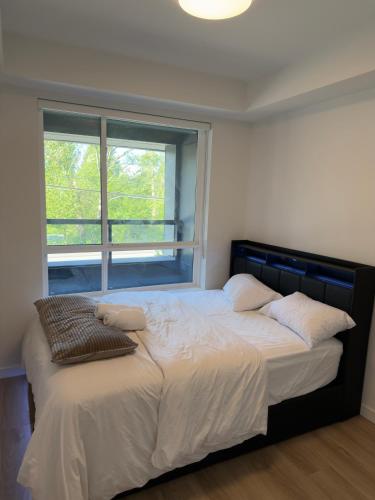 a bedroom with a large bed with a window at Downtown Escape in Surrey