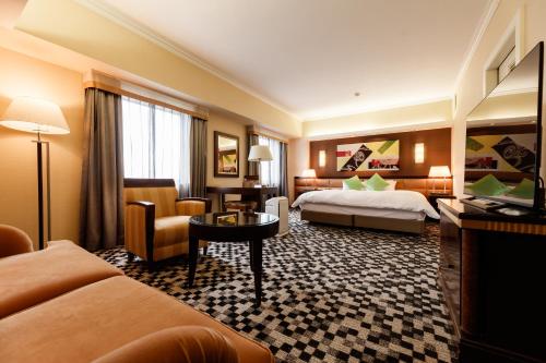 a hotel room with two beds and a table at Kanazawa New Grand Hotel Prestige in Kanazawa