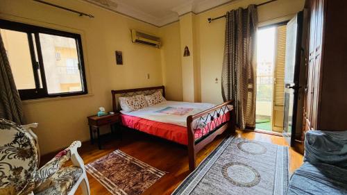 a bedroom with a bed in a room with a window at Temple host in Cairo