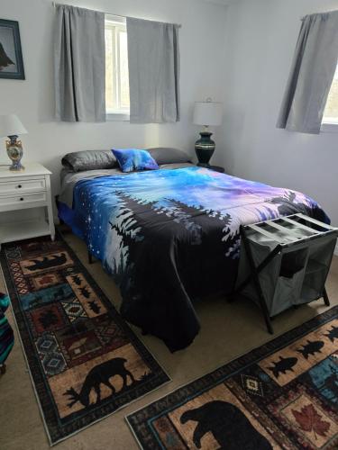 a bedroom with a bed in a room with rugs at Lillian's Cozy Corner in Palmer
