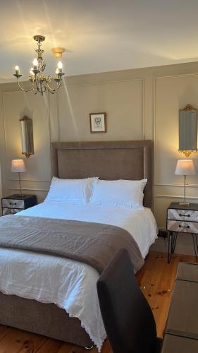 a bedroom with a large bed and a chair at The Lodge Self Catering Donegal Town in Donegal