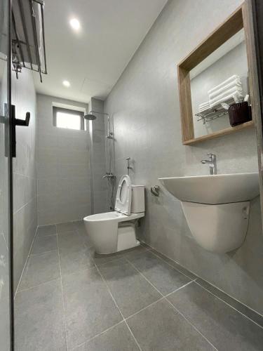 a bathroom with a toilet and a sink at Pi Home in Dong Hoi