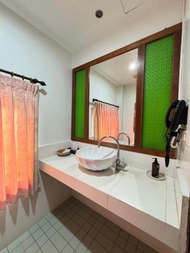 a bathroom with a sink and a large mirror at Pludhaya Resort & Spa in Phra Nakhon Si Ayutthaya