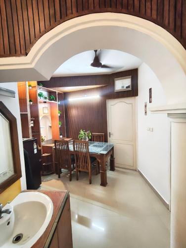a kitchen and dining room with a table and chairs at Sky Loft in Trivandrum