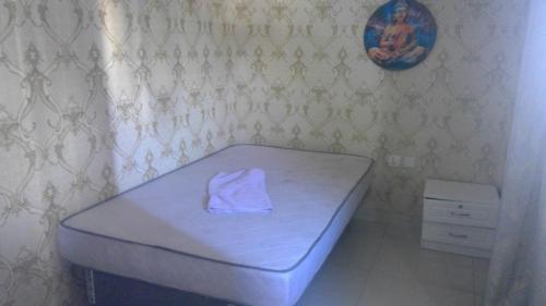 a bed with a towel on it in a room at wowspa in Ajman 