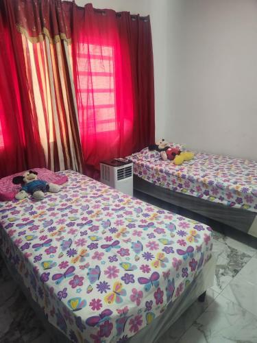 two beds with stuffed animals sitting on them in a room at Casa Lujosa in Choluteca