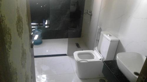 a small bathroom with a toilet and a sink at wowspa in Ajman 