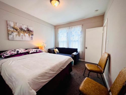 a bedroom with a bed and a chair and a couch at Niagara View at LaSalle SH in Niagara Falls