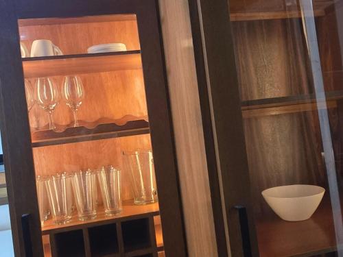 a cabinet with wine glasses and a bowl in it at RoofTop8 in Cochabamba