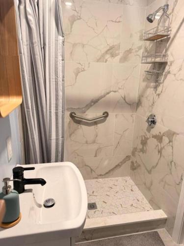 a bathroom with a sink and a shower at Ocean View Cozy Stay 4 in Hull