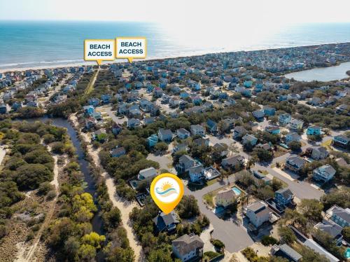 an aerial view of a neighborhood with houses and the ocean at 1602 - Here To Stay in Corolla