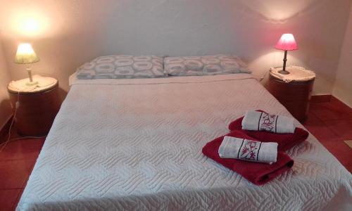 a bedroom with a bed with two pillows on it at Mini Apartamentos in Neptunia