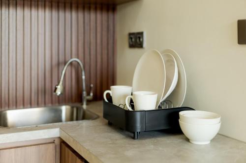 a kitchen with a sink and a counter with dishes at DC 08 Residence in Dalung