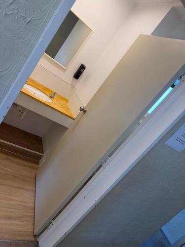 a room with a door with a surfboard on it at AAA Mana Motel in Porirua