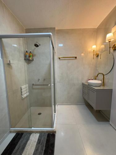 a bathroom with a shower and a sink at Pontal Beach Loft I in Rio de Janeiro