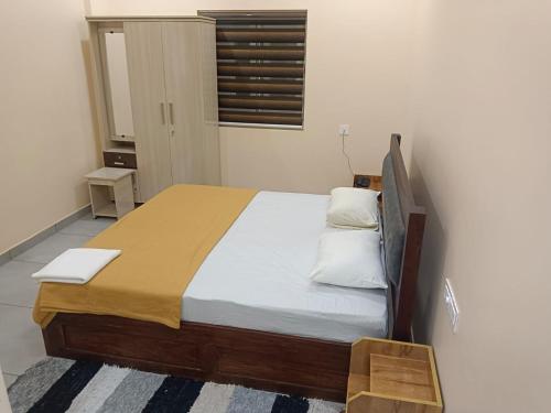 a bedroom with a large bed with white pillows at Hotel Sindoor Inn in Parli