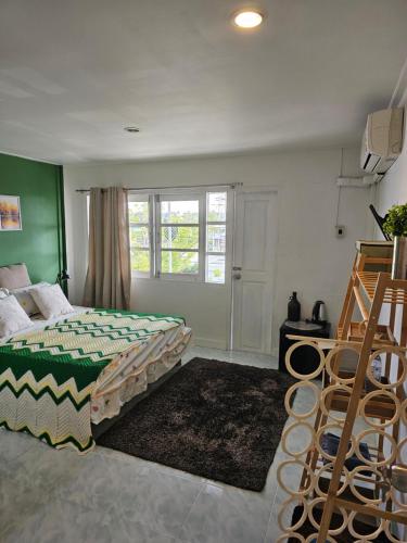 a bedroom with a bed and a window at Papa house in Pak Kret
