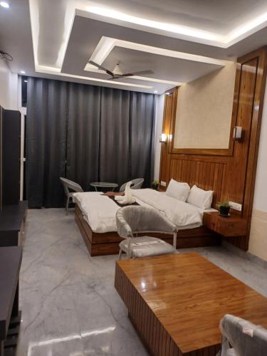 a living room with two beds and a table at Pahadi Basera Kasauli in Kasauli