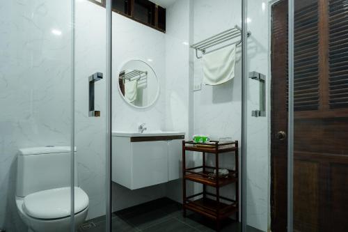 a bathroom with a toilet and a glass shower at Ban Lakkham River View in Luang Prabang