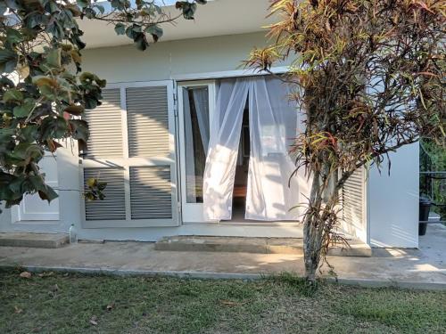a window with white curtains on a house at App F4 Kone centre RDC Tel 7O 55 O8 in Koné