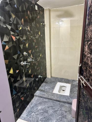 a bathroom with a shower with a toilet in it at Mitanvi the heaven in Ujjain