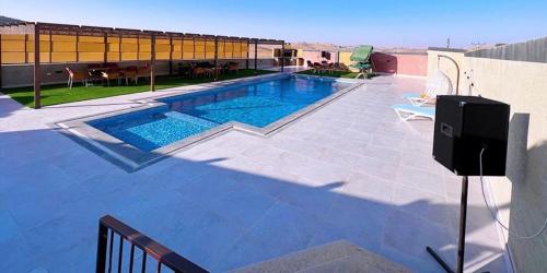 a swimming pool on top of a house at Al Maha Farm in Jerash