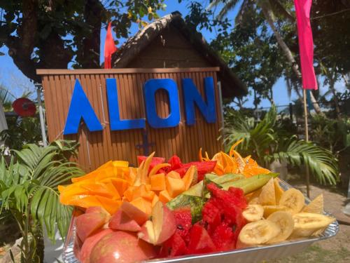 a plate of fruit and vegetables in front of a sign at Ālon in Linukso