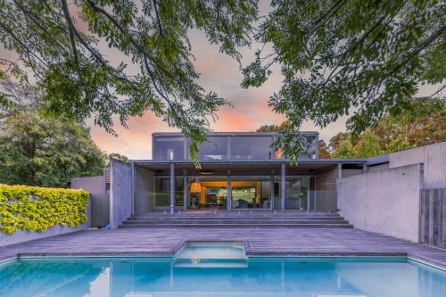an external view of a house with a swimming pool at Thule Country Estate - Private Architect-Designed Farm Estate, 6 Bedrooms, Sleeps 12 in Mount Macedon