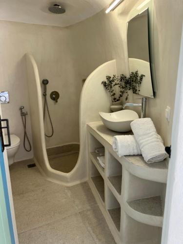 a bathroom with a sink and a large mirror at Naya seaside apartment in Firopótamos