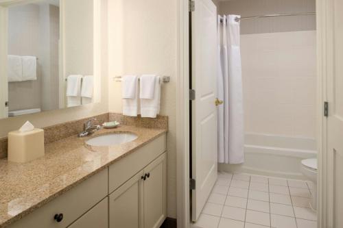 a bathroom with a sink and a toilet and a shower at Residence Inn Columbia in Columbia