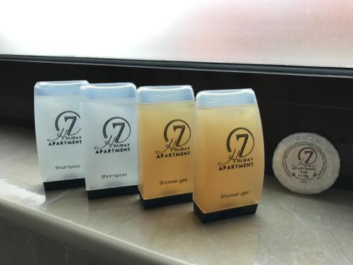 three bottles of shampoo sitting on a shelf at Holiday Apartment 7 in Hisarya