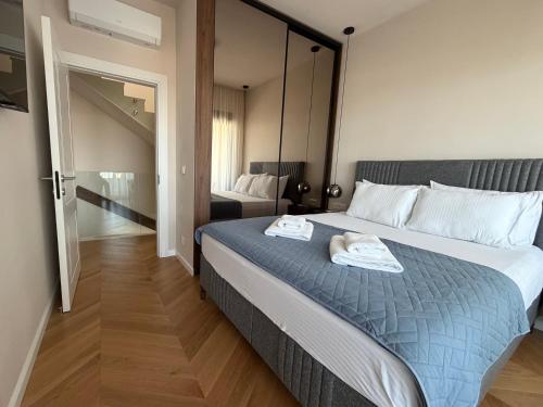 a bedroom with a bed with two towels on it at Villa MIO in Bar