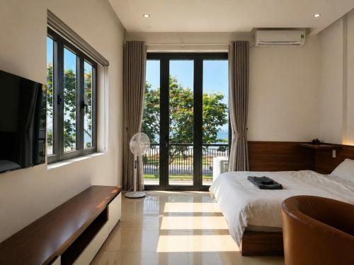 a bedroom with a bed and a large window at NOAM Stay - Sea Corner in Danang