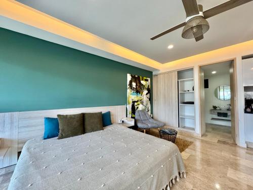 a bedroom with a large bed and a blue wall at Luxury Apartment top location! in Playa del Carmen